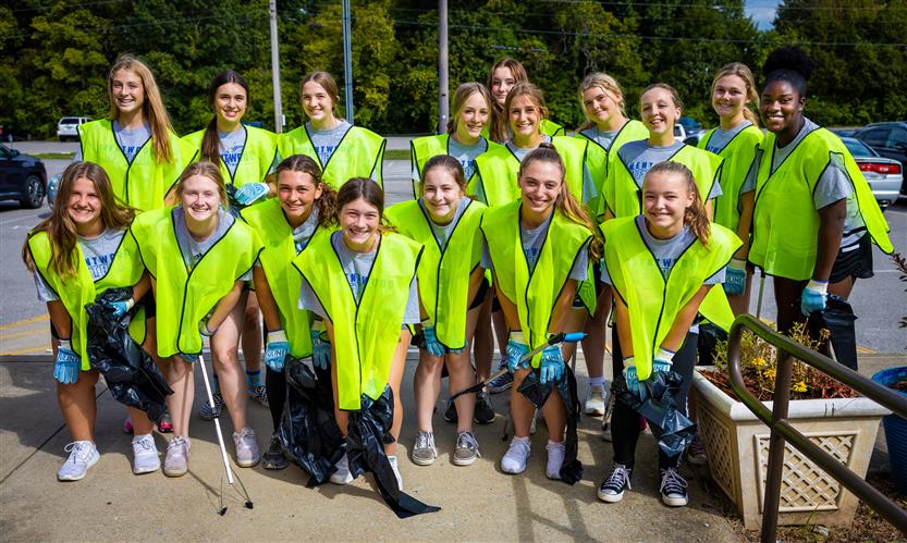 Softball team wearing neon vests